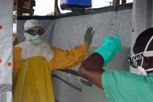 "Decontaminating CDC Director" by CDC Global - Decontaminating CDC Director. Licensed under Creative Commons Attribution 2.0 via  Wikimedia Commons  